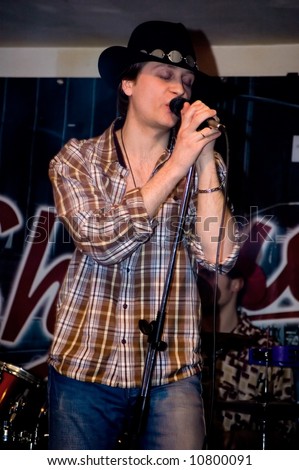 Singer with a microphone.  Concert of group StockDog in club the Woman-ljuba. Rostov-on-Don. Russia