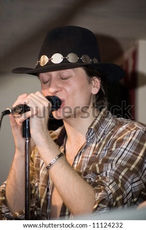 Singer with a microphone.  Concert of group StockDog in club the Woman-ljuba. Rostov-on-Don. Russia