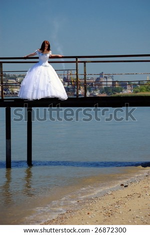 Bride on the old bridge looks down