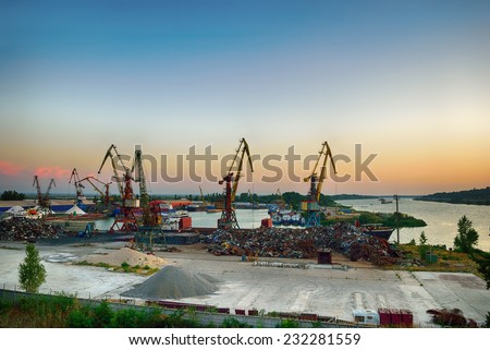 Scrap metal base with cranes on the river
