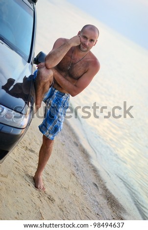 lean on a car guy at the beach