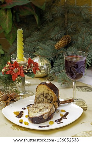 christmas cake with candle and red wine