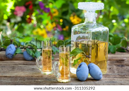 Bottle and two glasses with plum brandy