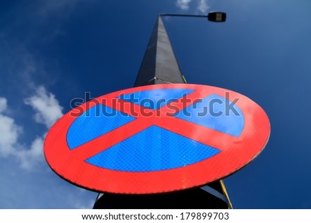 The urban clearway sign with blue skies in the background.