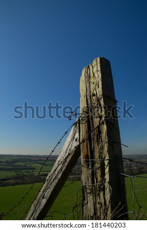 The old wooden fence overlooking the green English fields below in Parbold, England.