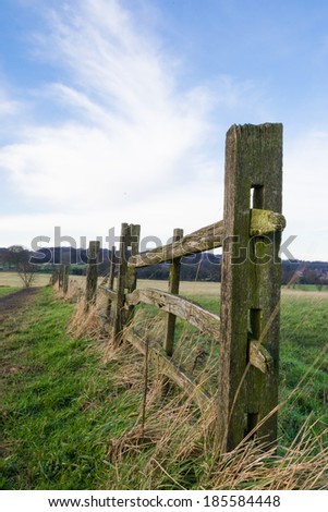 Old wooden fence outside of Northwestern English farmland in Wigan, England.