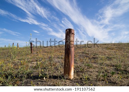 The rusted fence post in the Southern California desert.