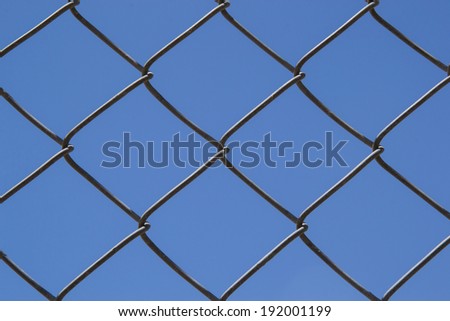The chain link fence with clear blue skies in the background.