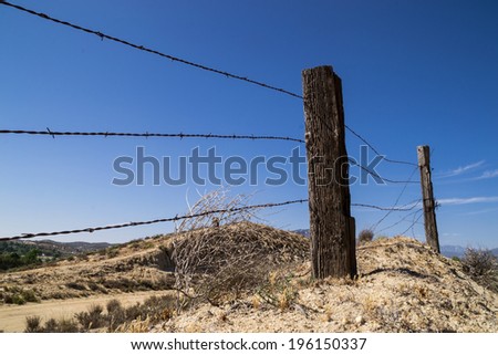 The old barbed wire fence in the California desert.
