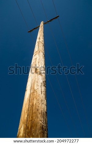 The single telephone pole with the deep blue California skies above.