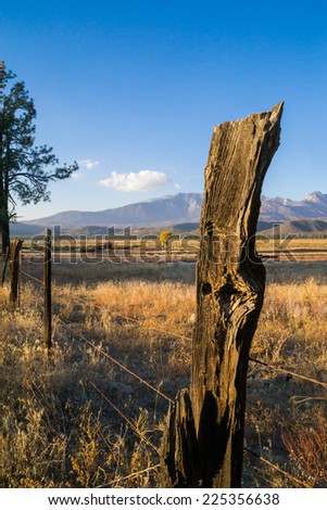 The old wooden fence post in the country before sunset.