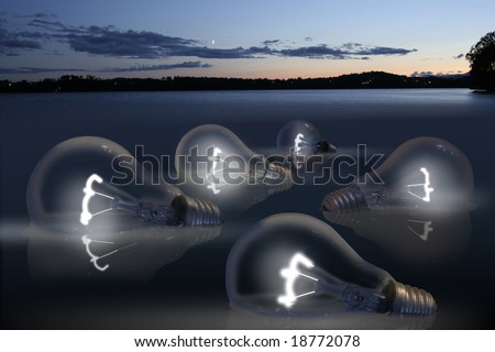 Floating bulbs glowing in water during dusk.