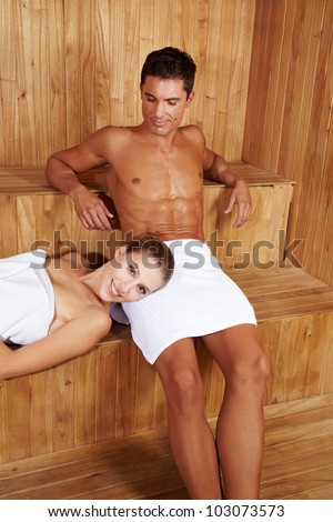 Happy couple relaxing together in a sauna