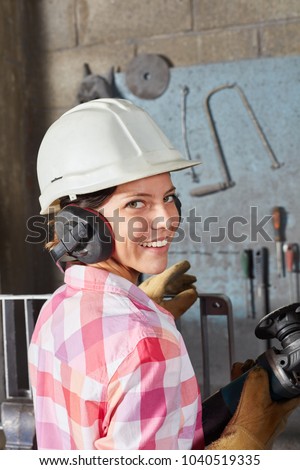 Woman as blue collar worker apprentice with labor protection