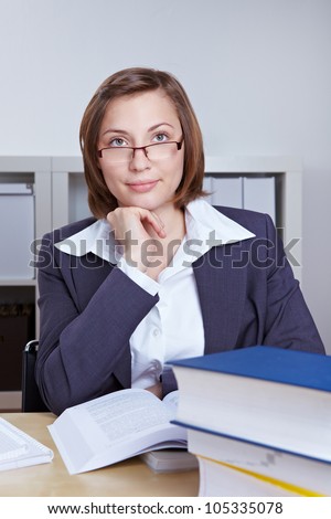 Female lawyer studying books in her office