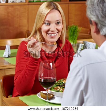 Happy elderly couple eating dinner together in a restaurant