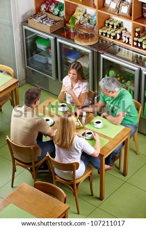 Group of regulars sitting together at table in a restaurant