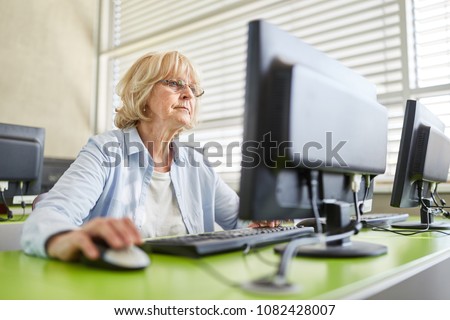 Senior woman learning and training in computer course