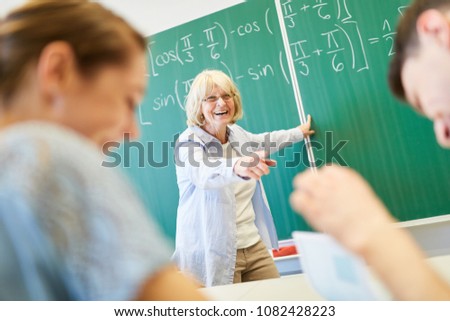 Teacher and students having fun in school at math class