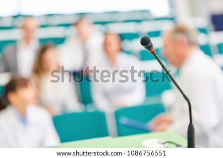 Doctors and students in medicine exam in university lecture hall
