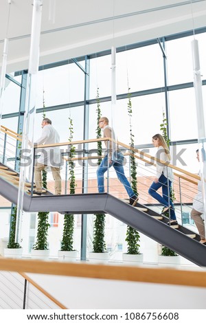 Hospital team group of doctors staff walk on staircase