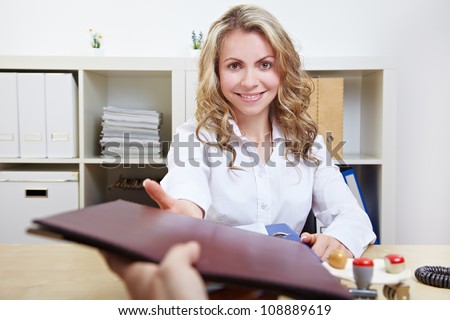 smiling HR woman having job interviews and receiving portfolios