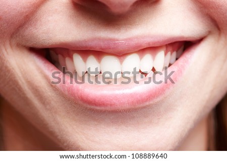 Close-up of smiling female mouth with white teeth showing