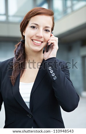 Attractive business woman making a phone call in the city