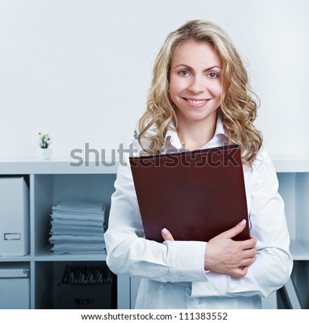 Happy blonde woman with CV and resume in the office
