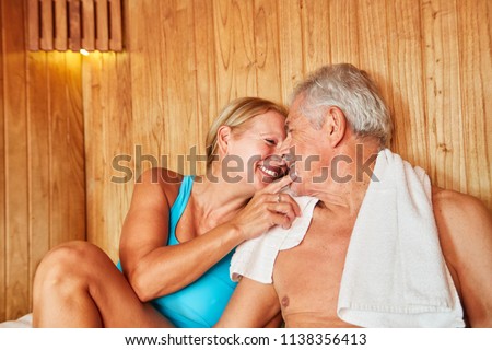 In love senior couple sitting together in the sauna at the Wellness Hotel