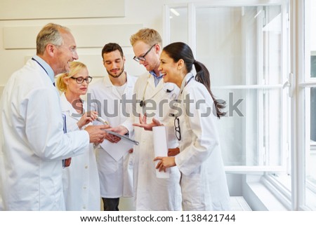 Team of successful doctors laughing with joy in meeting
