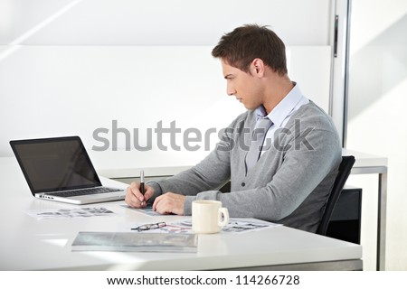 Creative student working with his laptop at desk