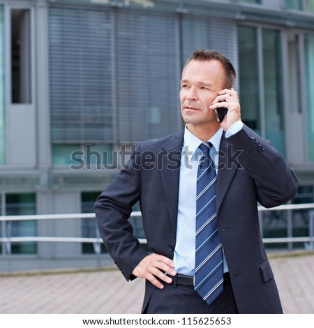 Busy business man using his smartphone to make a phone call