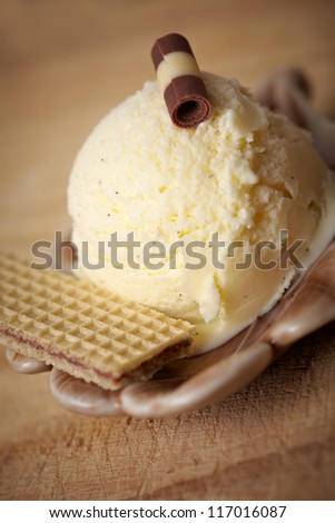 Homemade vanilla ice cream with waffle and decoration in a bowl