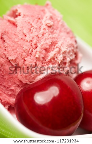 Scoop of delicious cherry ice cream with some cherries