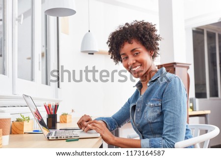Young multicultural student is learning computer while studying at laptop