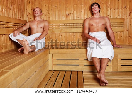 Two men sitting relaxed in a steam sauna