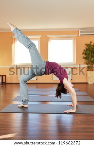 Young flexible woman doing the yoga wheel exercise Chakrasana