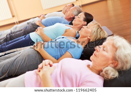 Elderly group doing neditation and relexation in a fitness center Elderly group doing neditation and relexation in a fitness center