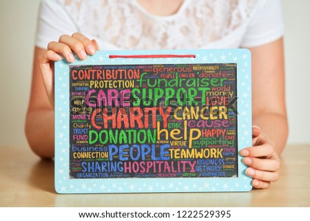 Collect donations at fundraiser for charity project with text on a blackboard