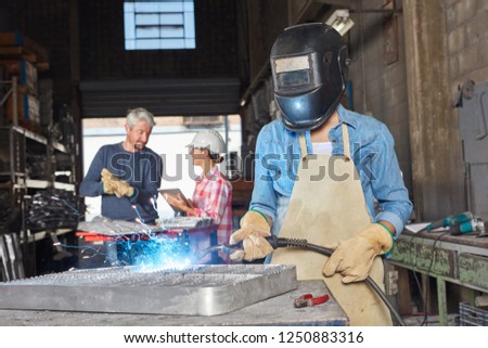 Weld worker or blue collar worker with protective clothing in workshop