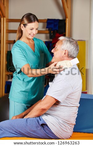 Old man with ruff neck and nurse at a physiotherapy