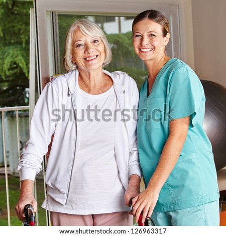 Happy Senior Woman With Walker And Nurse In A Physiotherapy