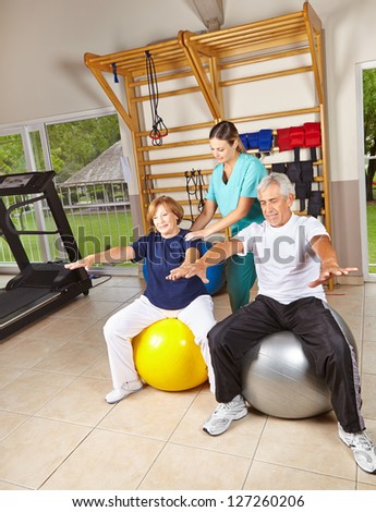 Senior people doing rehab gymnastics on gym balls