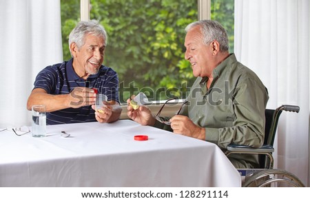 Two happy senior people taking medication in a nursing home