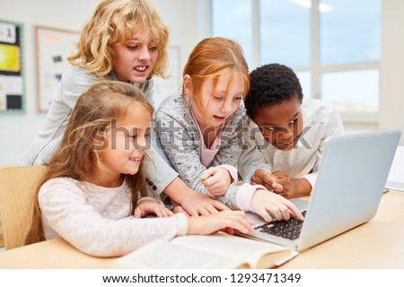 Group of kids at laptop computer learn how to deal with social media