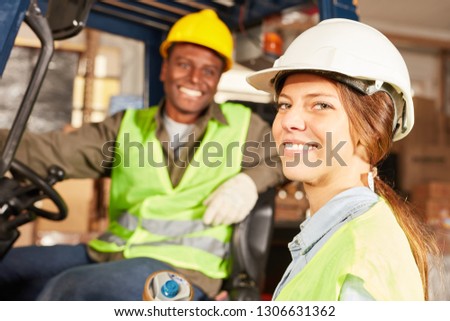 Logistics woman as a worker in training to warehouse specialist in the warehouse