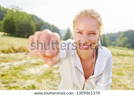 Young woman working out with her fist in the air as boxing exercise