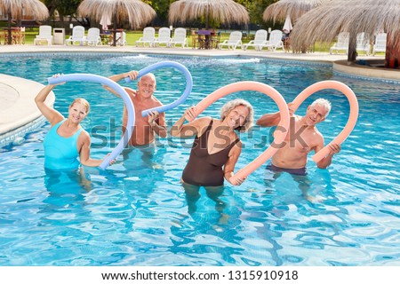 Vital seniors in the pool do aqua gym as a rehab course at the Spa Hotel