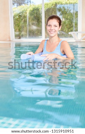 Young woman makes hydrotherapy in the spa pool of the spa hotel